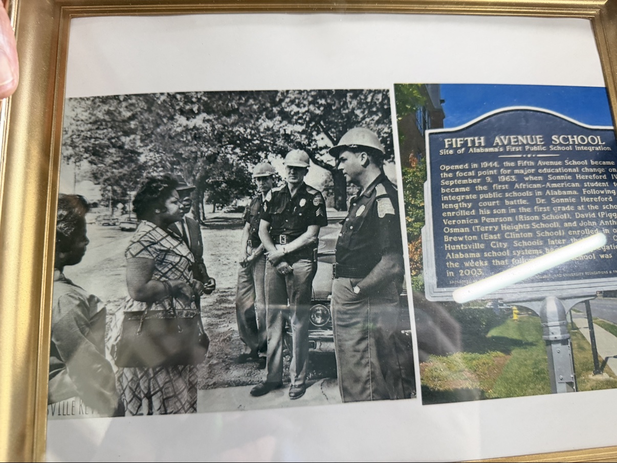 Framed photograph and Fifth Avenue School integration marker at Huntsville Revisited